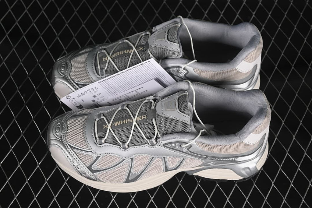 Pair of silver-gray XT-Whisper sneakers shown from above and the side.