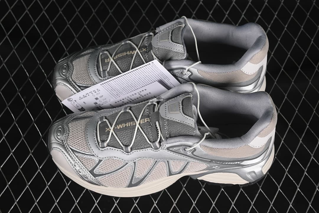 Pair of silver-gray XT-Whisper sneakers shown from above and the side.
