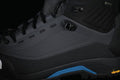 Close-up of the black hiking boot upper, lace hardware and blue outsole accent