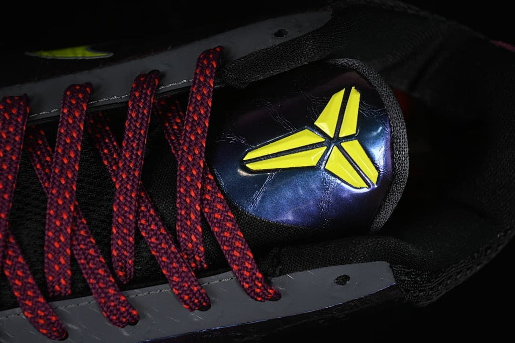 Close-up of the tongue emblem and burgundy laces