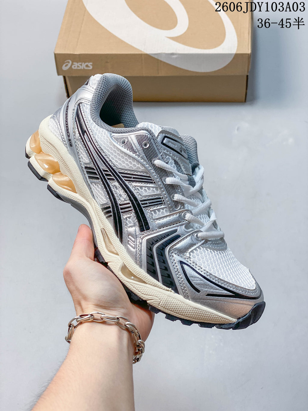 White and silver ASICS GEL-KAYANO 14 sneaker with dark accents