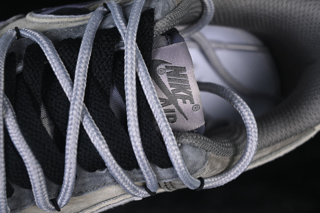 Close-up of the tongue label, black tongue, and gray laces