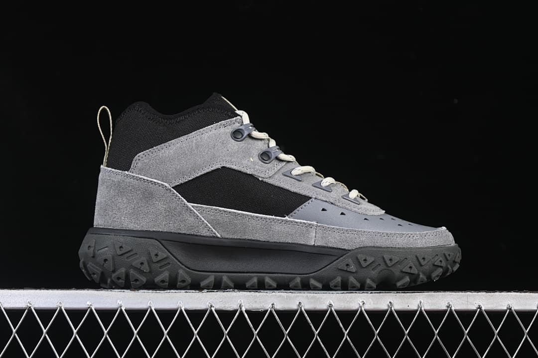 Side profile of the grey and black mid-cut sneaker.