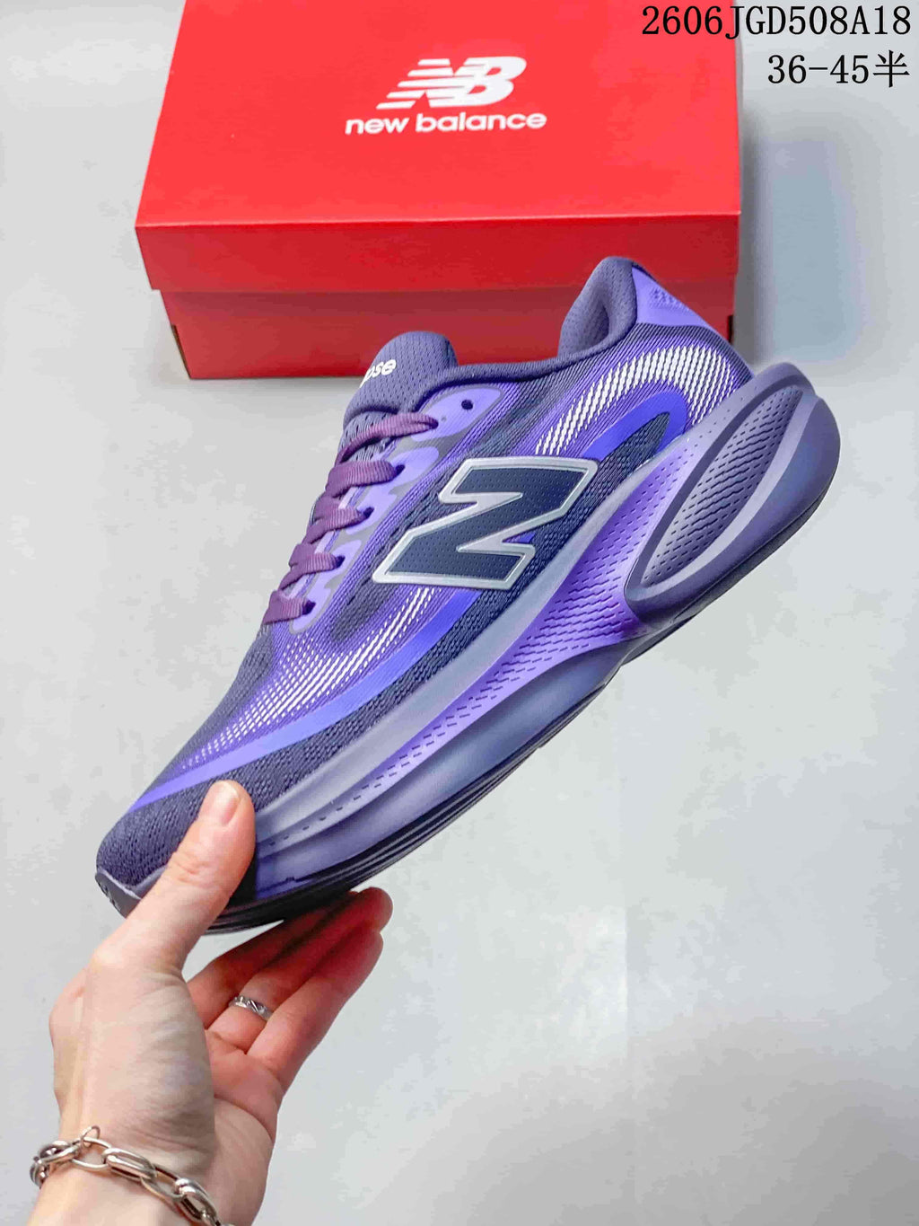 Side view of the purple running shoe with a large side logo