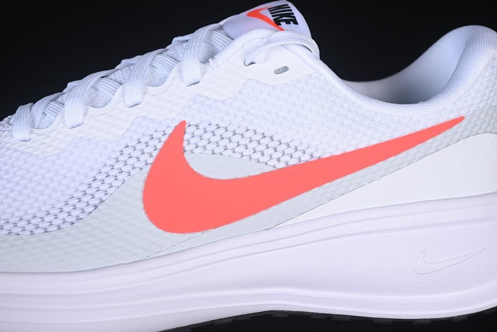 Close-up of the coral-colored Swoosh and textured white upper