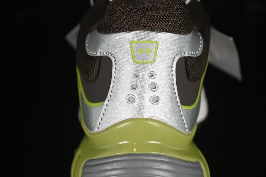 Rear view of the sneaker showing silver heel panels and lime midsole accents