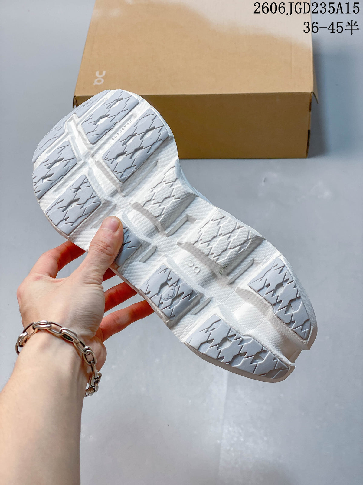 Underside view showing the segmented outsole of a white On Cloudmonster 3 sneaker