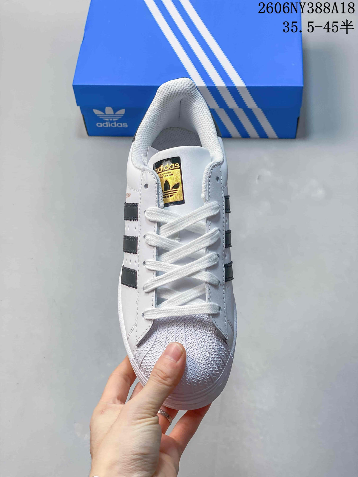 Front view of the sneaker showing white laces and a textured toe cap.