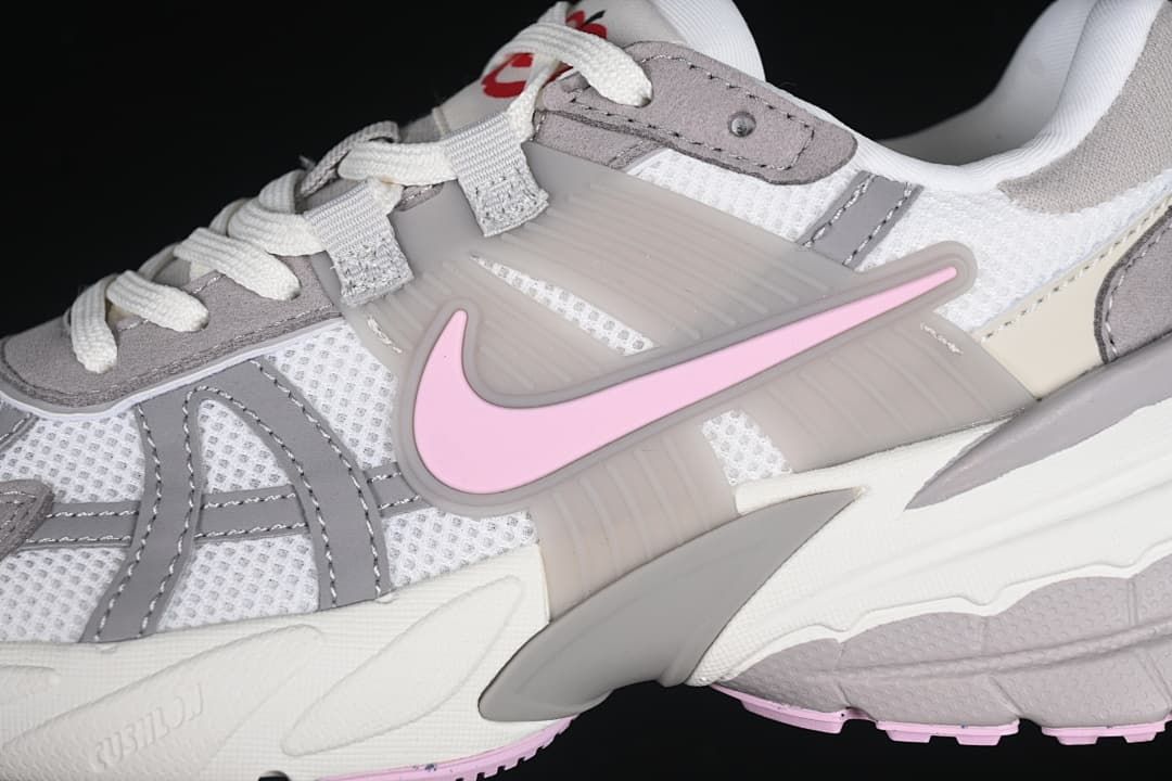 Close-up of the pink side Swoosh and layered upper panels