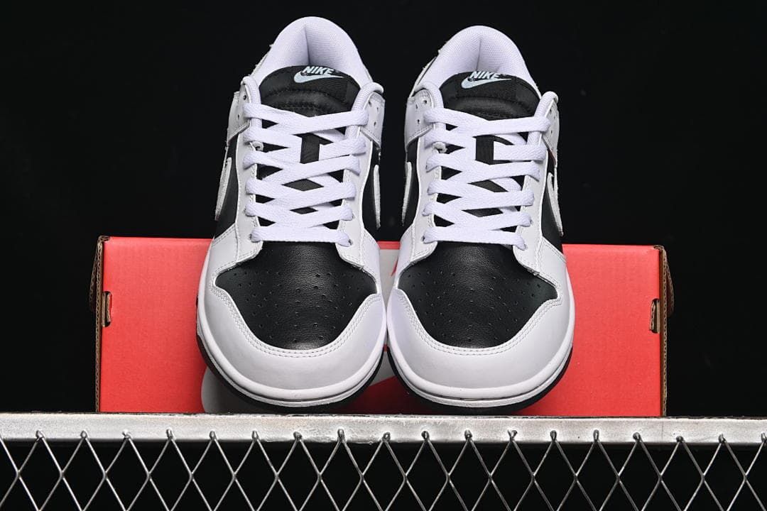 Front view of the pair of sneakers resting on a red shoe box