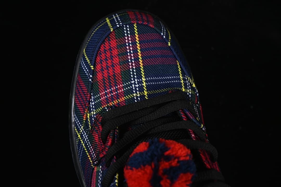 Top view of the plaid toe box, black laces, and fuzzy lace detail.