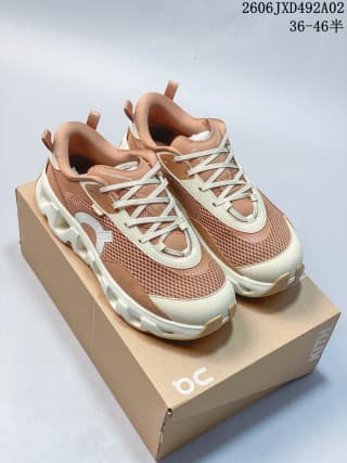 Pair of brown and cream sneakers displayed on a shoebox, showing the matching low-top design.