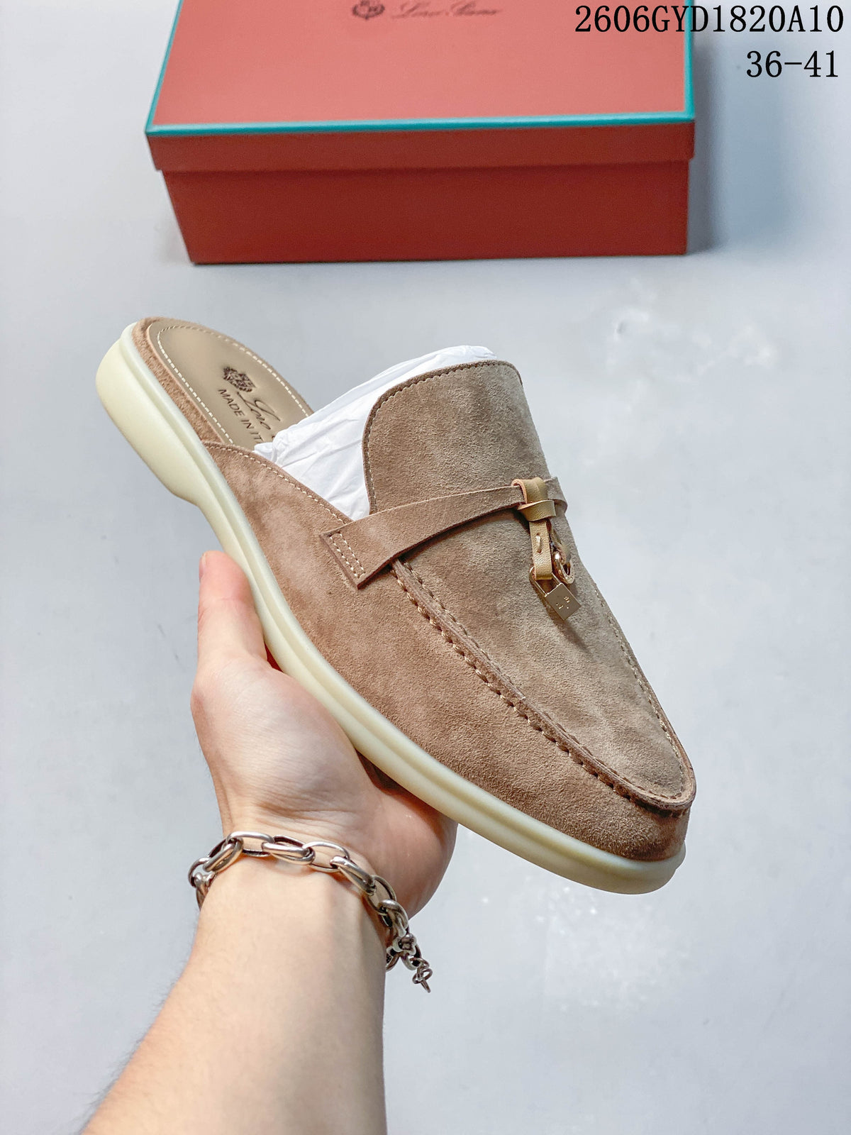 Angled side view of a taupe loafer mule with an open back