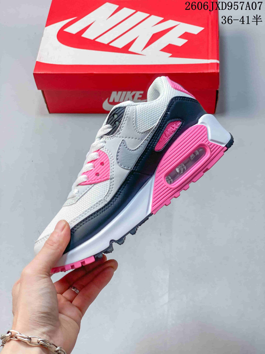 Side view showing the visible heel air unit and layered panels on a Nike Air Max 90 sneaker