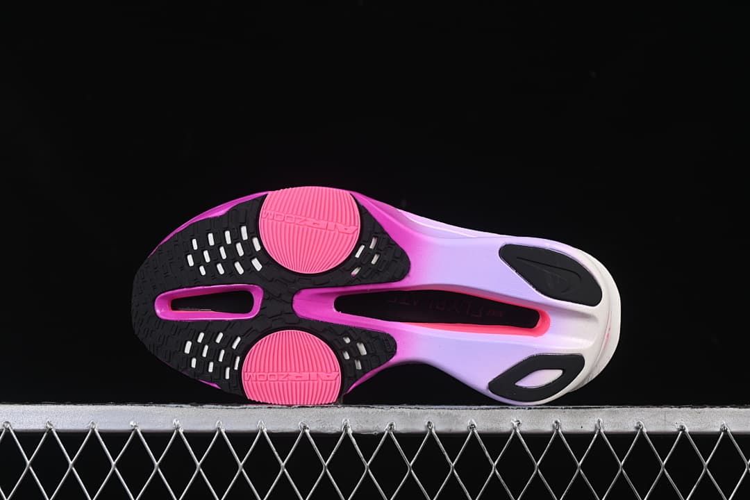 Underside view showing black and pink outsole sections.