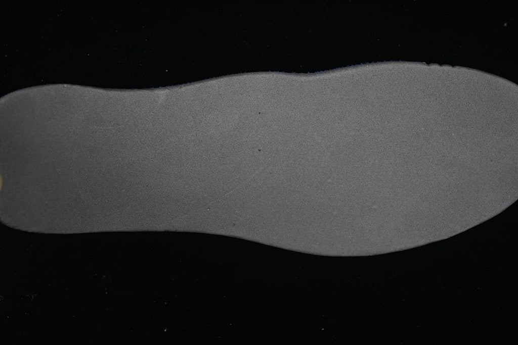 Gray shoe insole shown on a black background