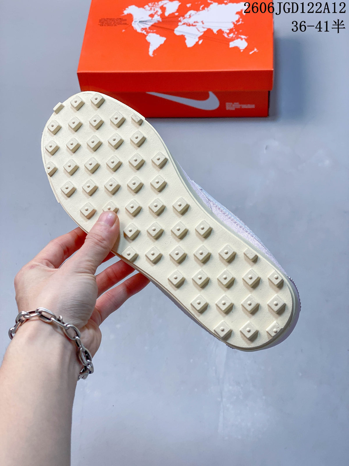 Cream-colored outsole with raised lug tread on the pink sneaker