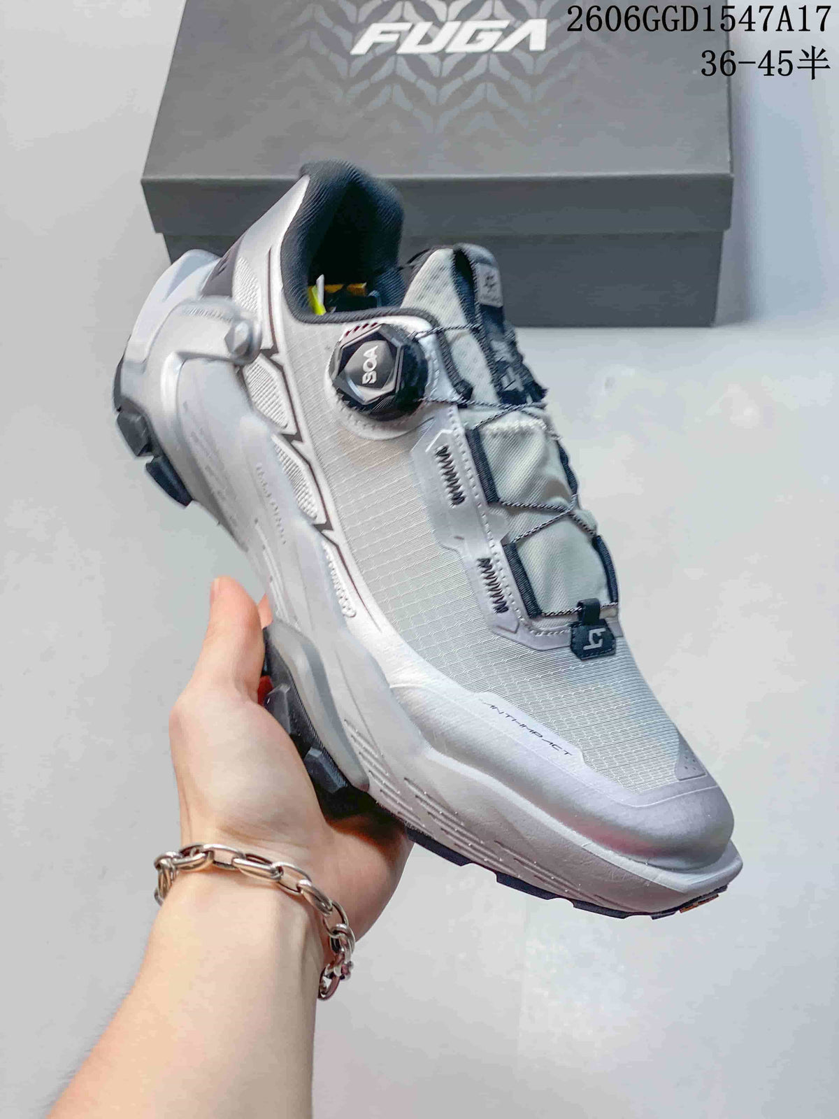 Angled view of a silver-gray trail shoe with a visible BOA dial and lugged sole.