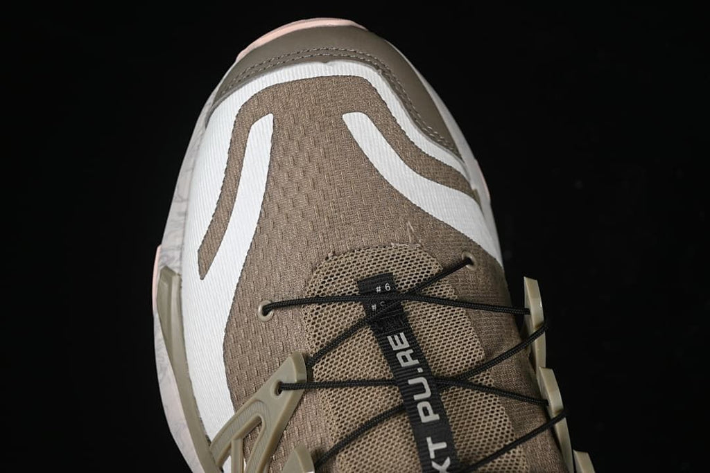 Top view of the taupe mesh toe and cord lacing