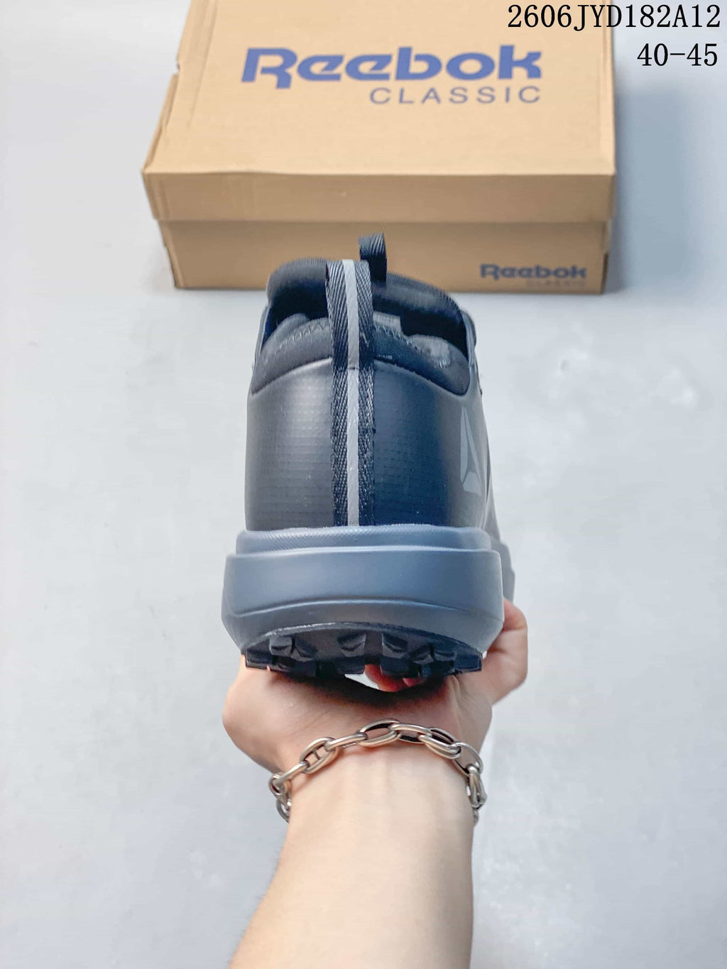 Rear view of the grey sneaker showing the heel pull tab