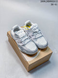 Pair of silver and light gray ASICS Hypersync sneakers shown on a shoebox
