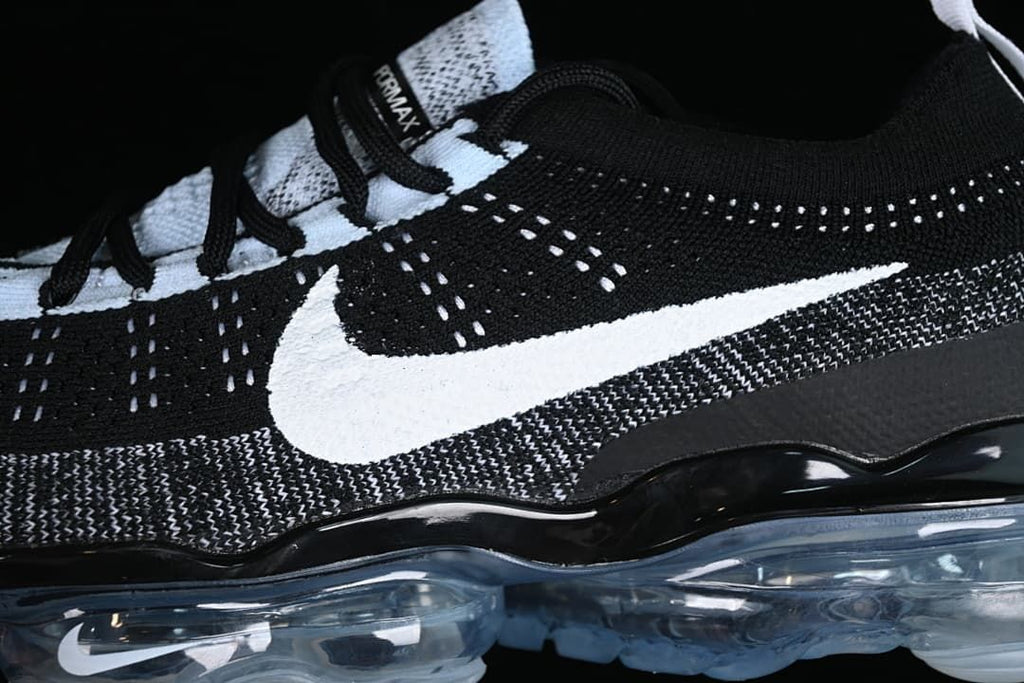 Close-up of the knit upper, white side Swoosh, and visible sole.