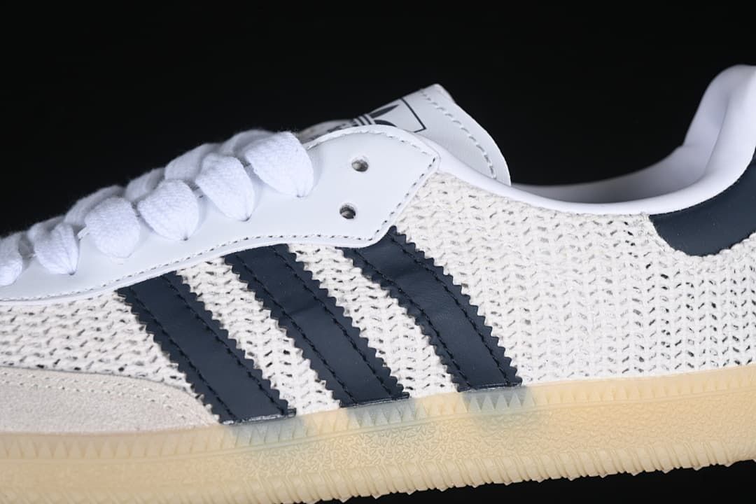 Close-up of the navy side stripes, textured upper, and gum-look sole