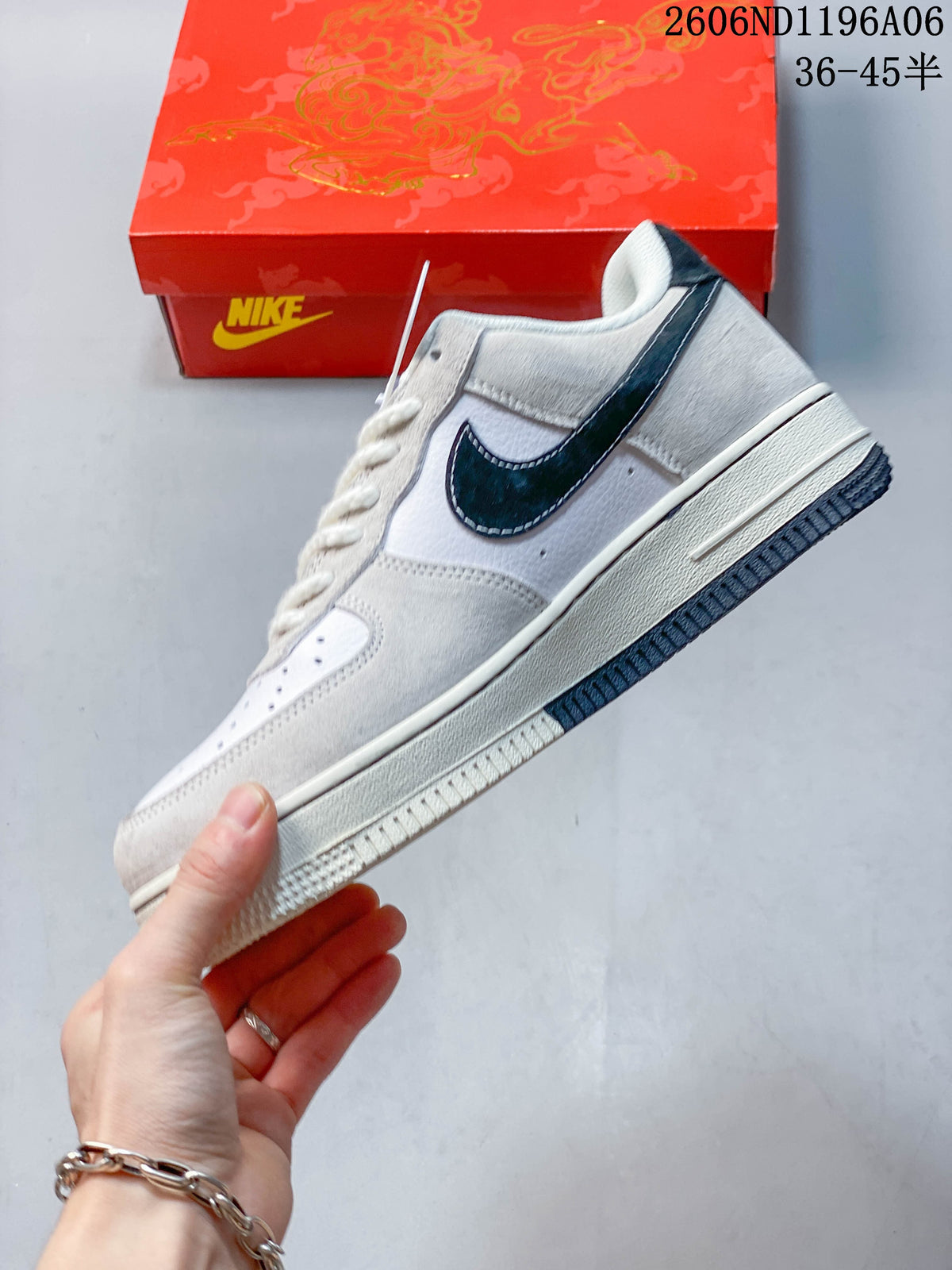 Side profile of a white and grey low-top Nike Air Force 1 with a dark Swoosh.