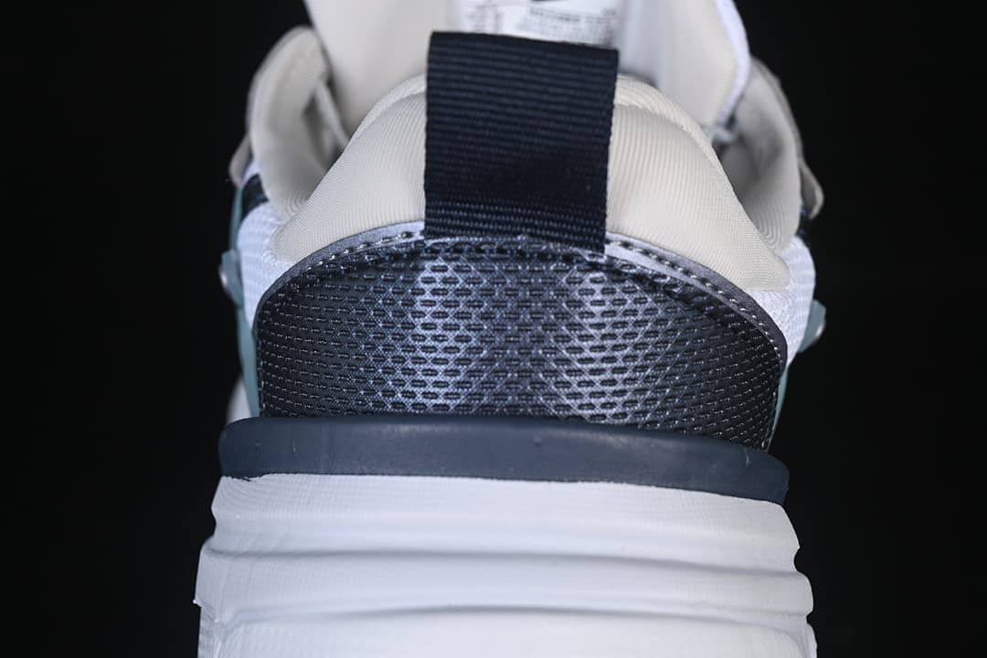 Rear view highlighting the dark textured heel panel and pull tab.
