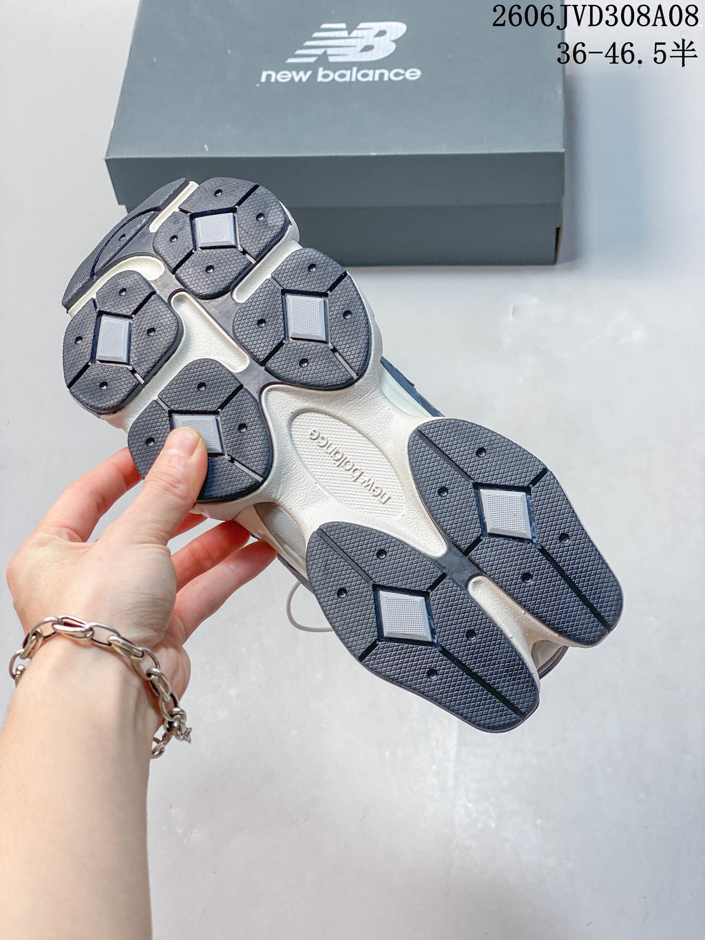 Underside of a New Balance 9060 sneaker showing the segmented dark outsole