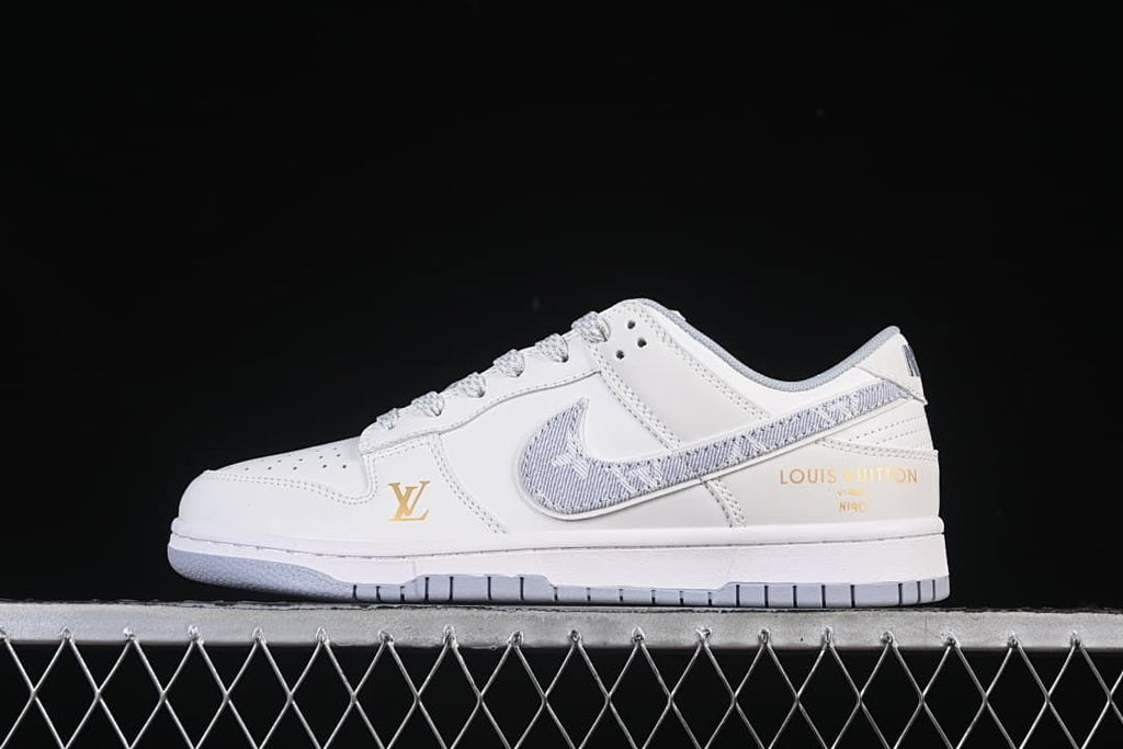 Side view of a white low-top sneaker with a gray patterned Swoosh and gold-tone branding