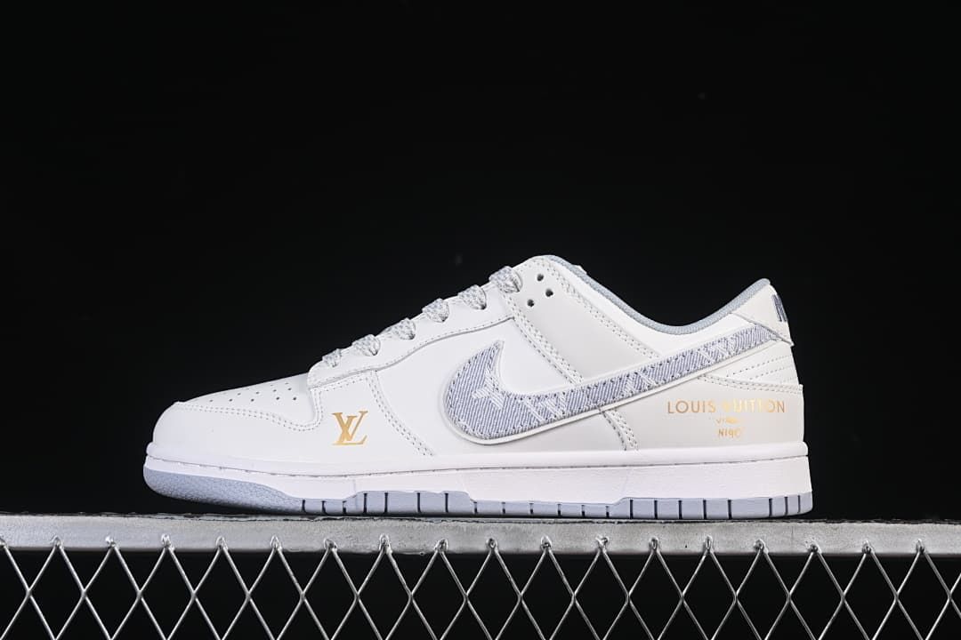 Side view of a white low-top sneaker with a gray patterned Swoosh and gold-tone branding