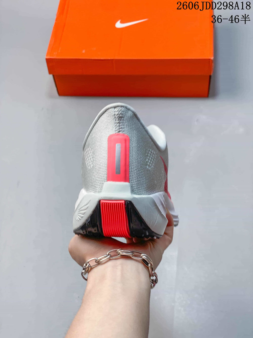 Rear view of the gray shoe with coral heel detail