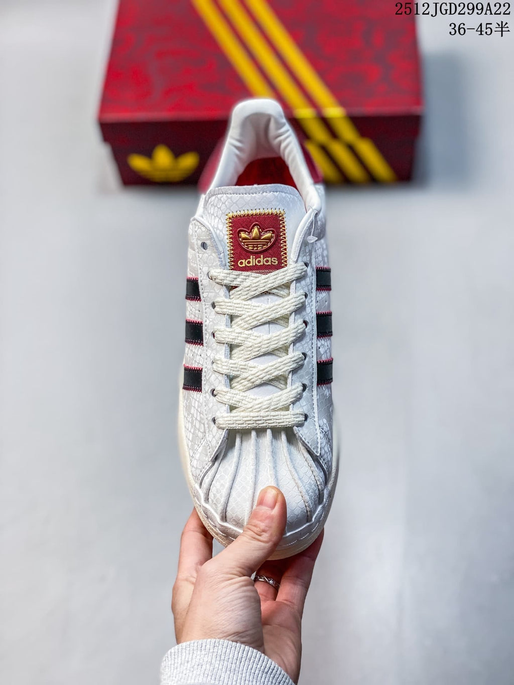Front view highlighting the shell toe, white laces, and burgundy tongue label.