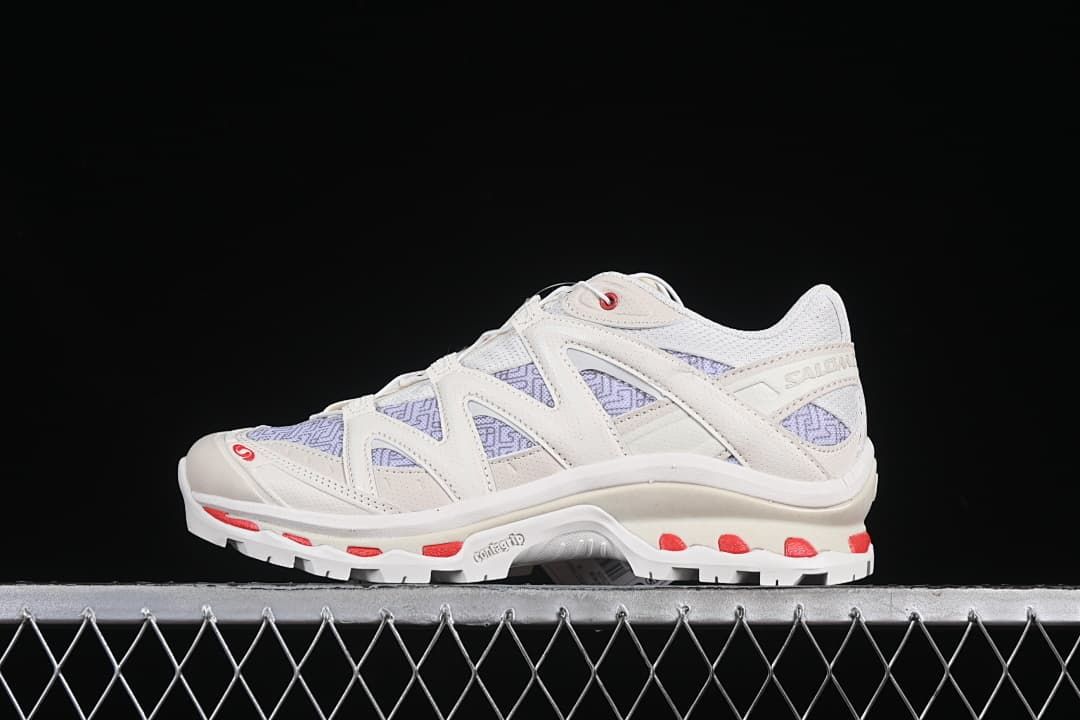 Side view of a Salomon XT-Quest Panhui shoe in pale vanilla tones with lavender patterned panels and red accents.