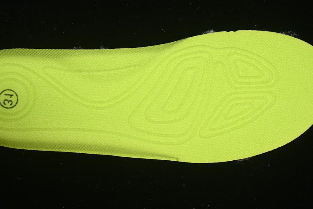 Bright yellow-green shoe insole with a size marking.