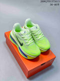 Pair of fluorescent green Nike Vomero Premium running shoes on an orange shoebox