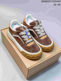 Pair of brown Louis Vuitton low-top sneakers with white laces and gum-colored soles