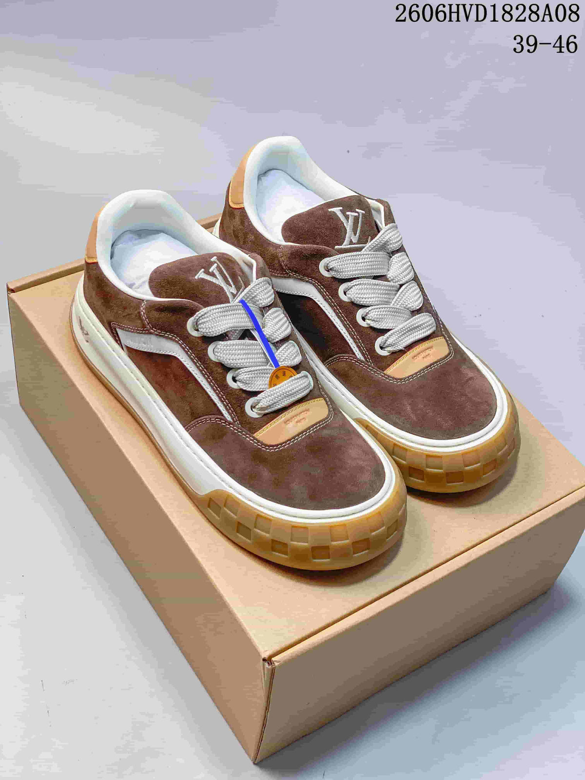 Pair of brown Louis Vuitton low-top sneakers with white laces and gum-colored soles
