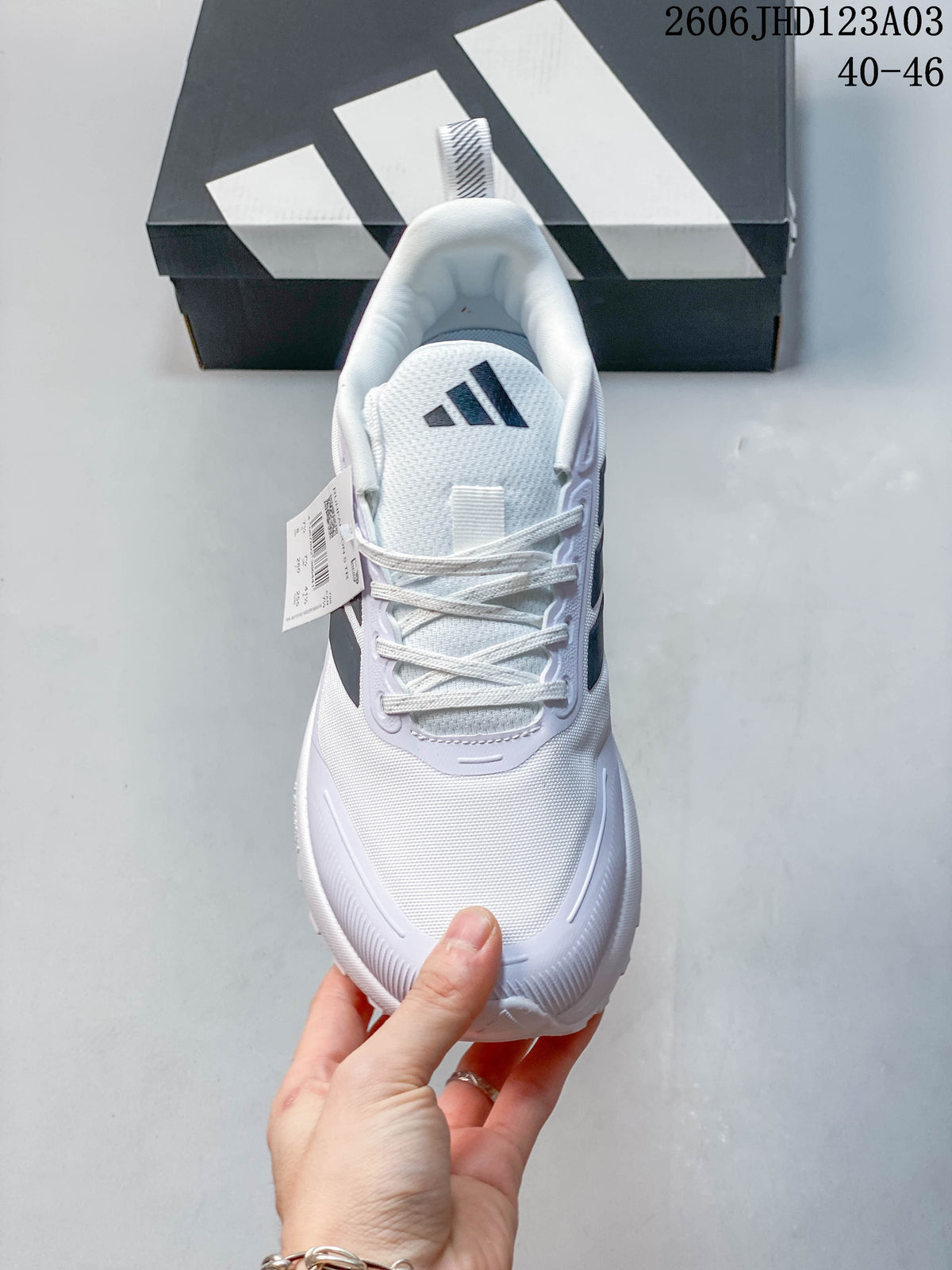 Top view of a white lace-up sneaker with black logo details