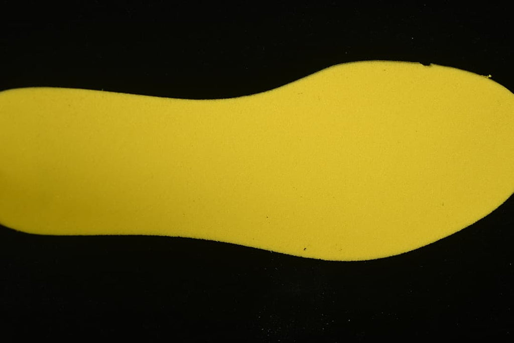 Yellow shoe-shaped insert photographed separately