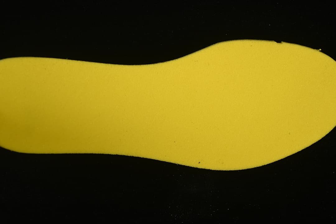 Yellow shoe-shaped insert photographed separately