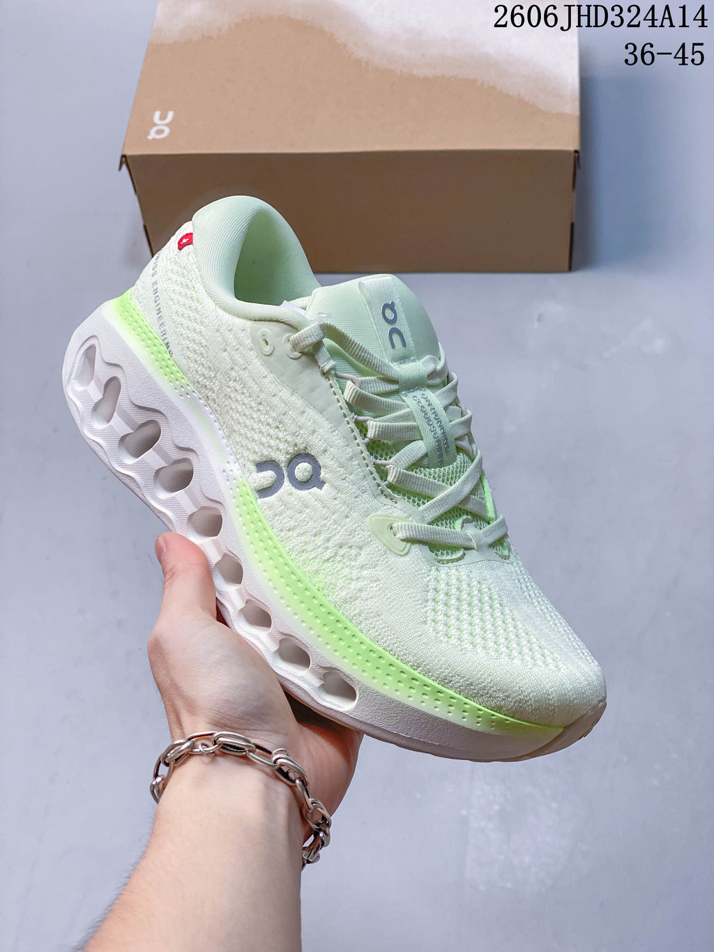 Side view of a white shoe with light green midsole accents