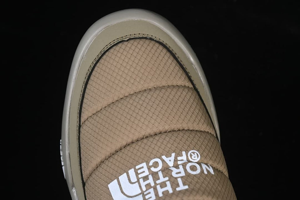 Top-down view of the shoe's quilted toe and strap