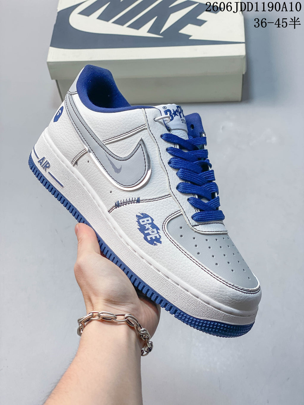 Angled side view of a white and blue low-top sneaker