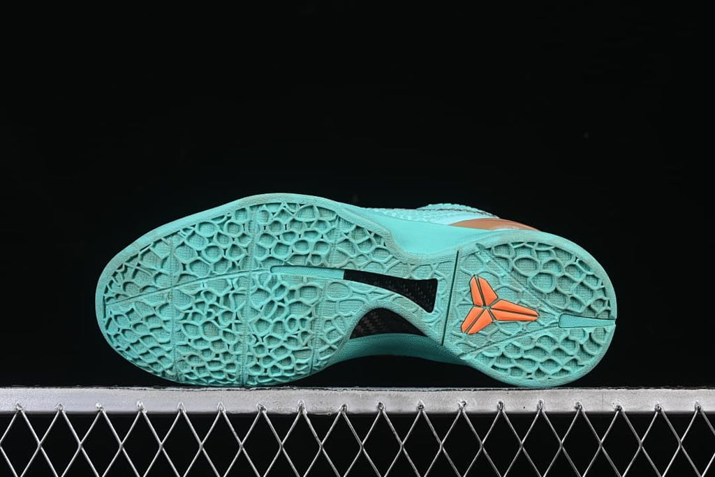 Underside view showing the turquoise patterned outsole and contrasting center details.