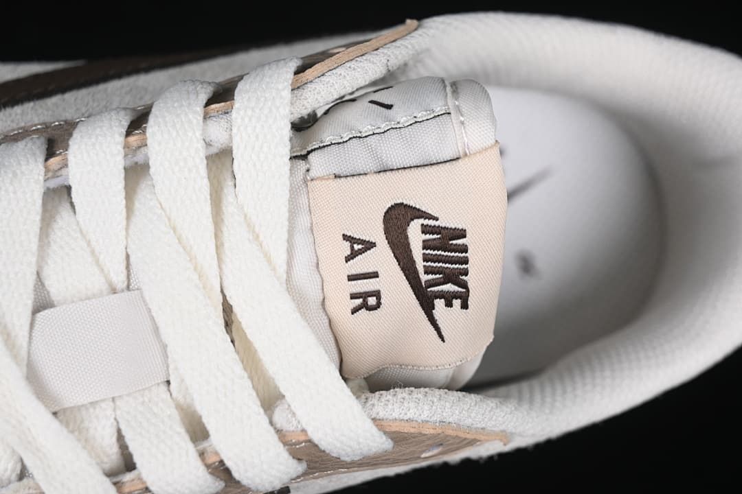 Close-up of the tongue label, white laces, and collar.