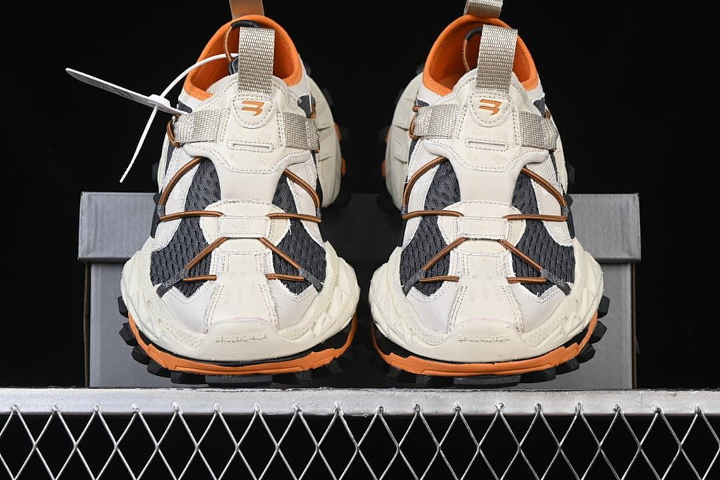 Front view of the pair showing the layered uppers and orange accents