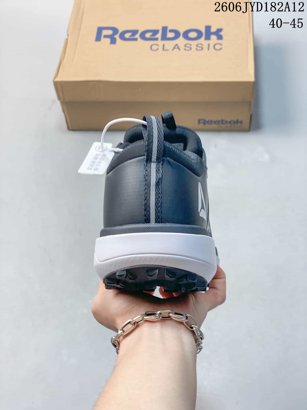 Rear view of a Reebok sneaker with a white midsole