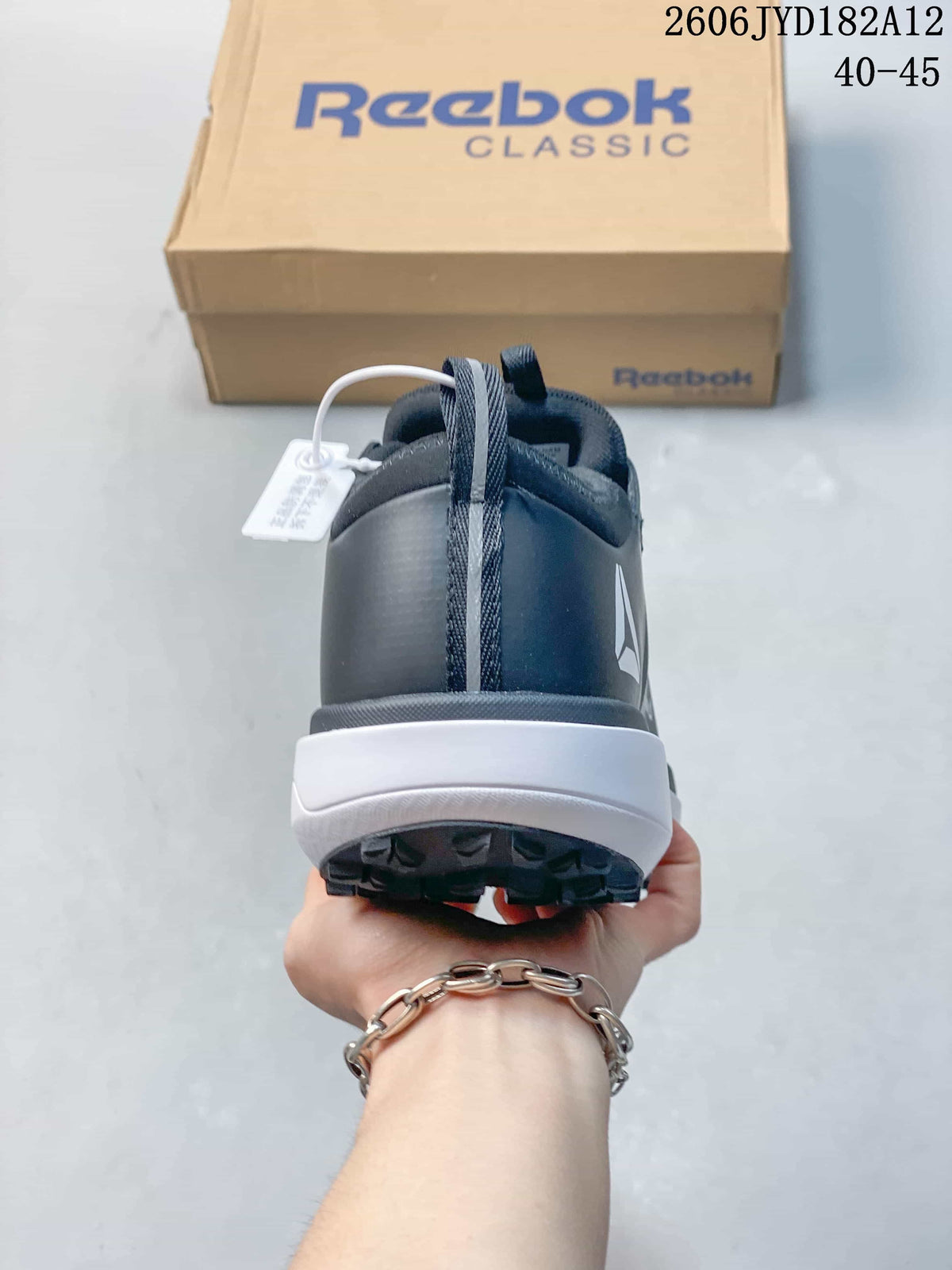 Rear view of a Reebok sneaker with a white midsole
